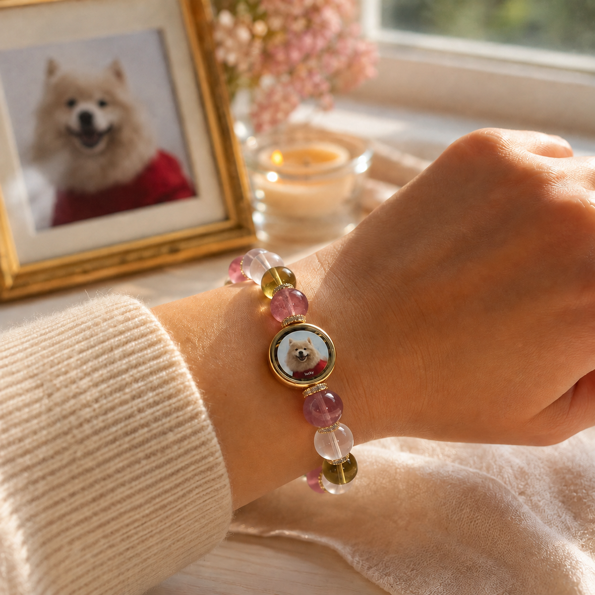 A pet parent wearing a personalized memorial bracelet beside a cherished pet portrait